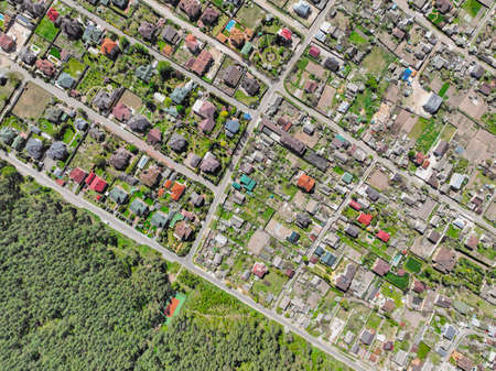 Suburban houses near the forest at summer day - aerial drone top view shot.の写真素材