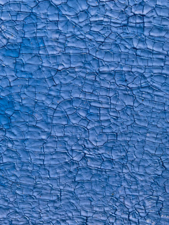 Texture of blue cracked paint on a wooden surfaceの写真素材