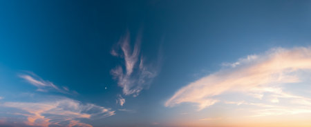 Rays of the setting sun break through the clouds - wide shotの写真素材