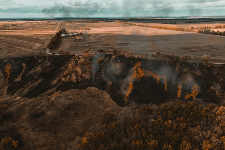 Forest fire near the village - Aerial drone top view.の写真素材