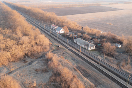 Railway station among the fields in autumn: several old buildings and a railway - high angle viewの写真素材
