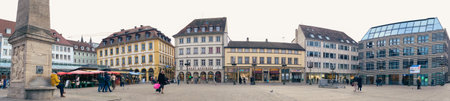 Busy city scene with blurred buildings, people, and treesのeditorial素材