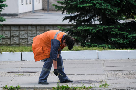 Municipal Worker Cleaning Sidewalkの写真素材