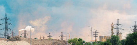 Wide Industrial Landscape with Power Lines and Smoke Stacksの写真素材