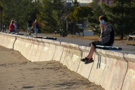 The Bliss of Youthful Solitude while relaxing by the Beautiful Beach during sunsetの写真素材