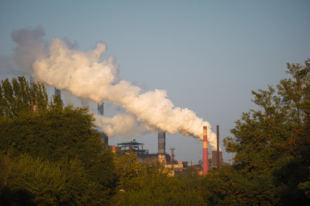 Industrial Emissions Generated from Factory Operations Releasing Smoke Plumes into the Airの写真素材