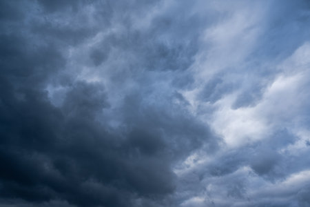 The mesmerizing view of a moody sky filled with dark, brooding clouds creates a strong sense of drama and atmospheric tension, making it an ideal choice for themes related to weather phenomenaの写真素材