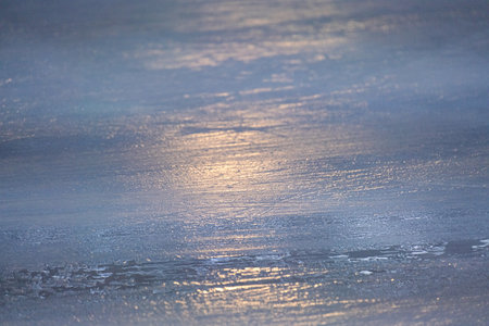 A beautiful, serene view of an icy surface that is reflecting soft light, which creates a calm and captivating visual atmosphere that evokes feelings of tranquility and peace in natureの写真素材