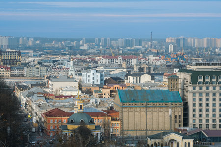 A panoramic view of the Podil district in Kyiv, featuring historic architecture, modern buildings, and the Ferris wheel on Kontraktova Square.の写真素材