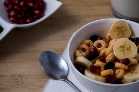 Plate with corn flakes and fruits on wooden background