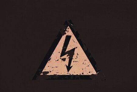 Electric shock symbol on vintage peeled wall. の写真素材