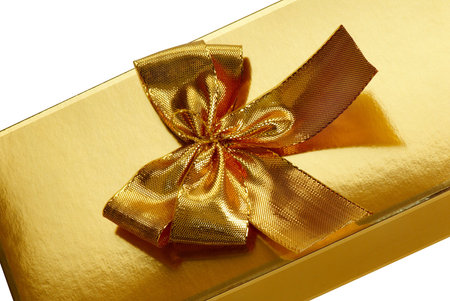 A gold boxed gift with gold ribbonの写真素材