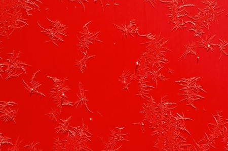 Frost Ice-flower  on a red surface of carの写真素材