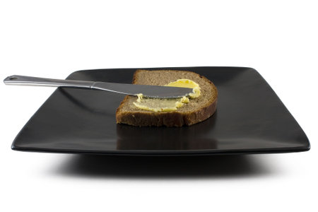 A slice of rye health bread with butter spreadの写真素材