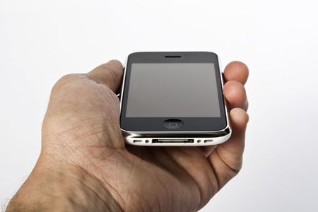 Close up of a man's hang holding a state of the art touch screen phone.のeditorial素材