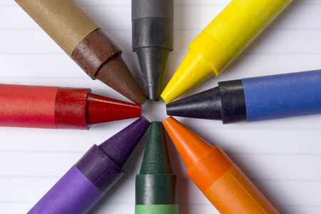 Various color crayons on white lined paperの写真素材