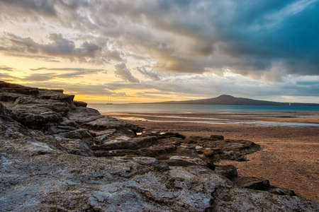 Sunset over the sea from St Heliers beach, Auckland, New Zealand.の写真素材