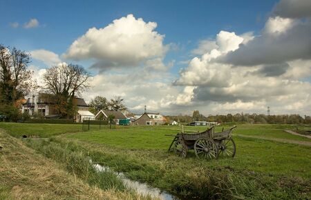 Old wooden cart standing in a countryside in a fieldの写真素材