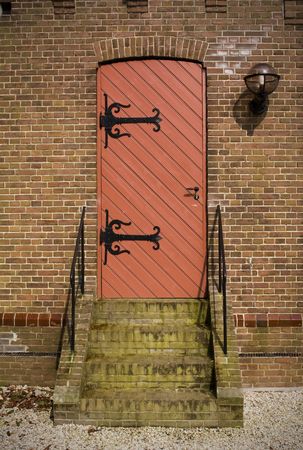 An old wooden door. Backdoor of the church in Schiedam, Netherlands.の写真素材