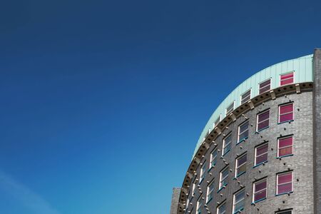 Close-up shot of the modern building in the Hague, the Netherlands Clean blue sky, nice place for the titleの写真素材