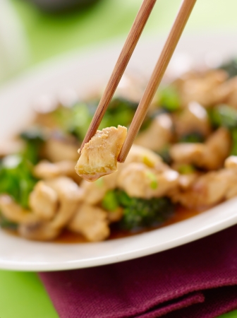 stir fry chopstick closeup eating chicken and broccoliの写真素材