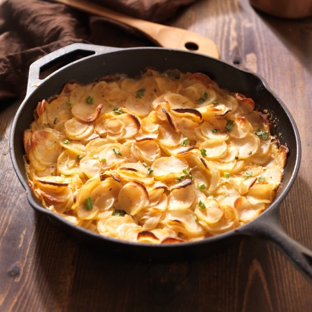 scalloped potatoes in rustic iron skilletの写真素材