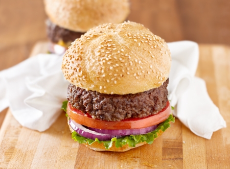 hamburger with white napkin on wooden board.の写真素材