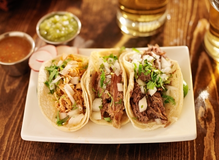 authentic mexican barbacoa, carnitas and chicken tacosの写真素材