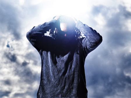 african man holding up dreds with dramatic light 