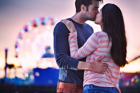 young couple kissing near santa monica pierの写真素材