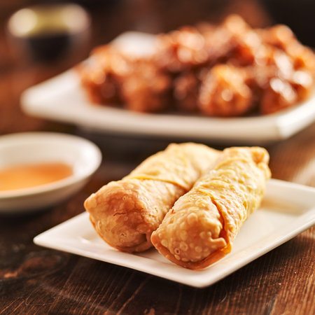 two chinese egg rolls on plate