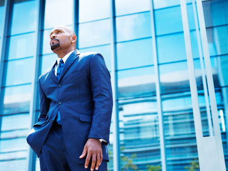 african american businnesman in front of glass office building