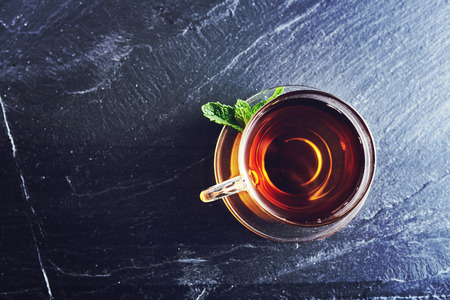 top down photo of a glass of tea on slateの写真素材