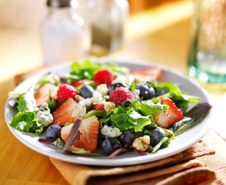 berry salad with blue cheese crumbles and walnutsの写真素材