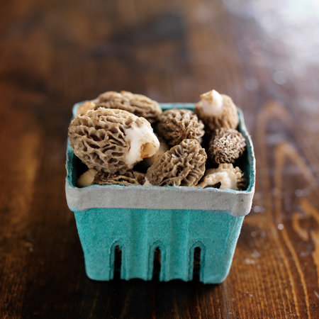 basket of moral mushrooms on wooden table