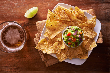 tortilla chips with guacamole and beer shot top down