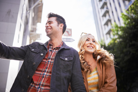romantic couple walking down street in los angelesの写真素材