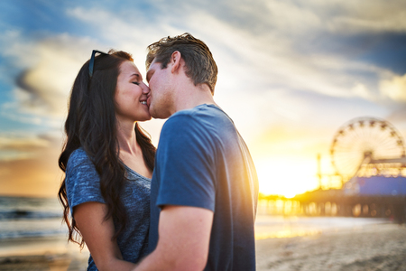 romantic couple kissing at santa monicaの写真素材
