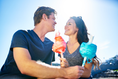 romantic couple on date on sunny summer day with cotton candyの写真素材