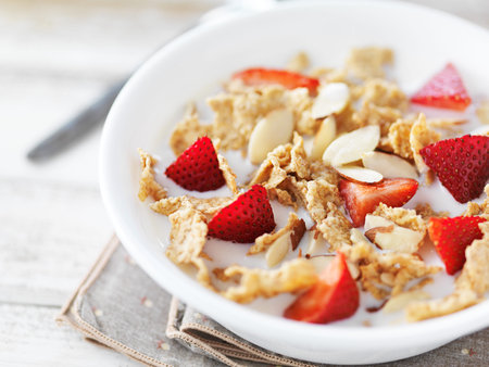 bowl of cereal with strawberries and almonds