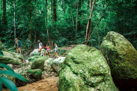 group of hikers exploring jungle in thailandの写真素材