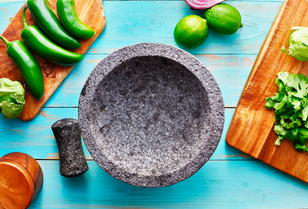 empty molcajete on table with ingredients ready to prepの写真素材