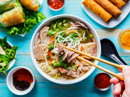 eating colorful vietnamese pho bo with chopsticks from top down viewの写真素材
