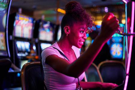 happy woman gambling at casino playing slot machine