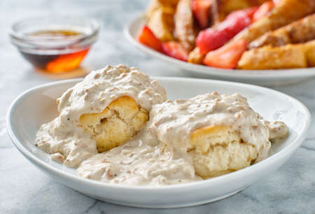 biscuits and gravy with sausage on plateの写真素材