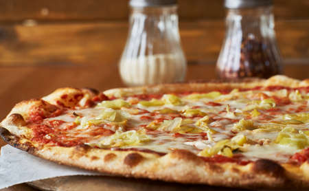 thin crust pizza with yellow peppers and tomato sauceの写真素材