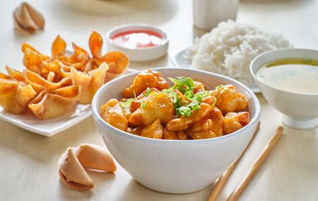 chinese food with orange chicken, crab rangoon and fortune cookieの写真素材