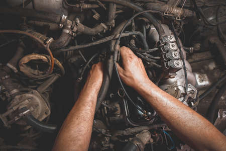 auto repair under the hood male hands dirtyの写真素材