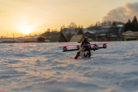fpv drone lies on the snow flying surveillance racing pink winter