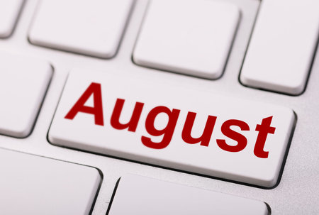 AUGUST word on the keyboard button. Close-up.